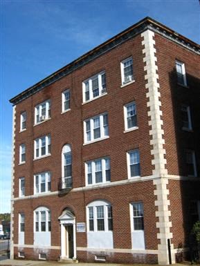 a red brick building with white trim and windows