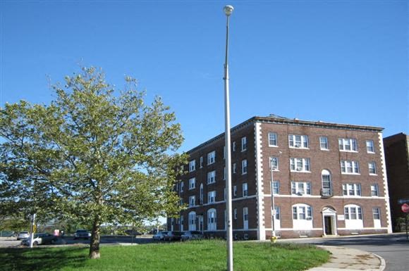 a large brick building on the side of a street