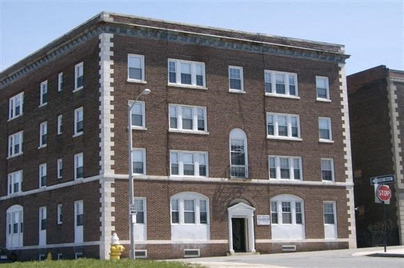 a large brick building on the side of a street