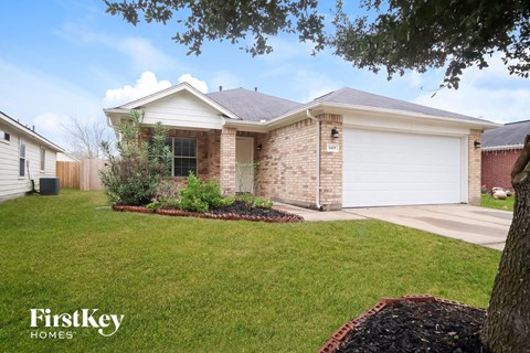 A house with a white garage door and a brick exterior.