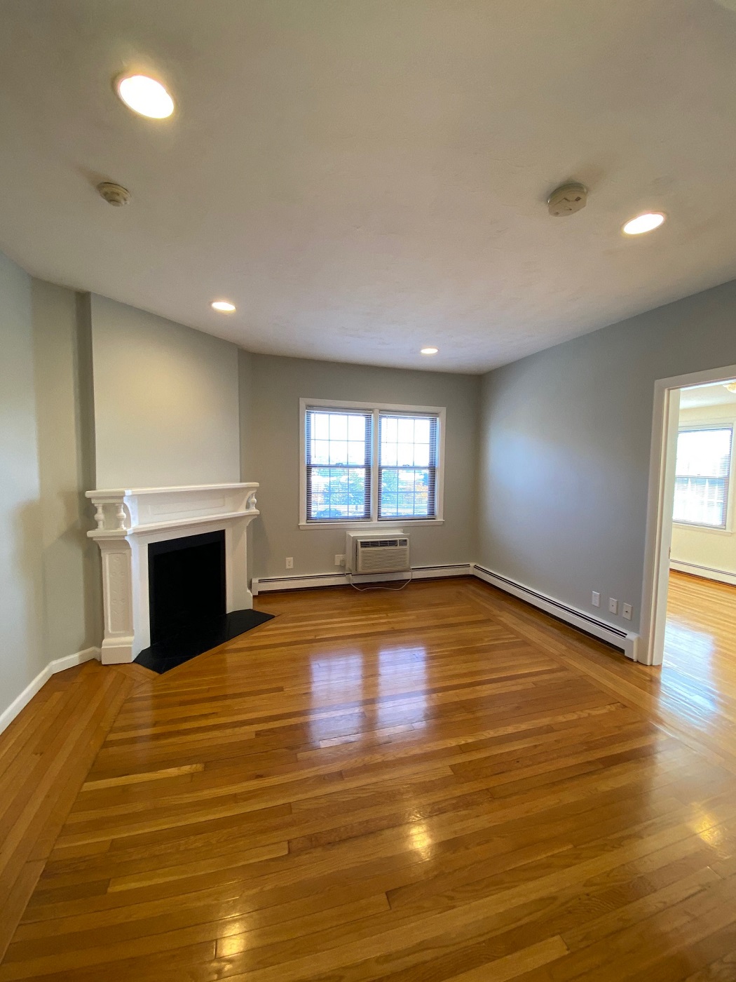Living room with hardwood floors and non working fireplace