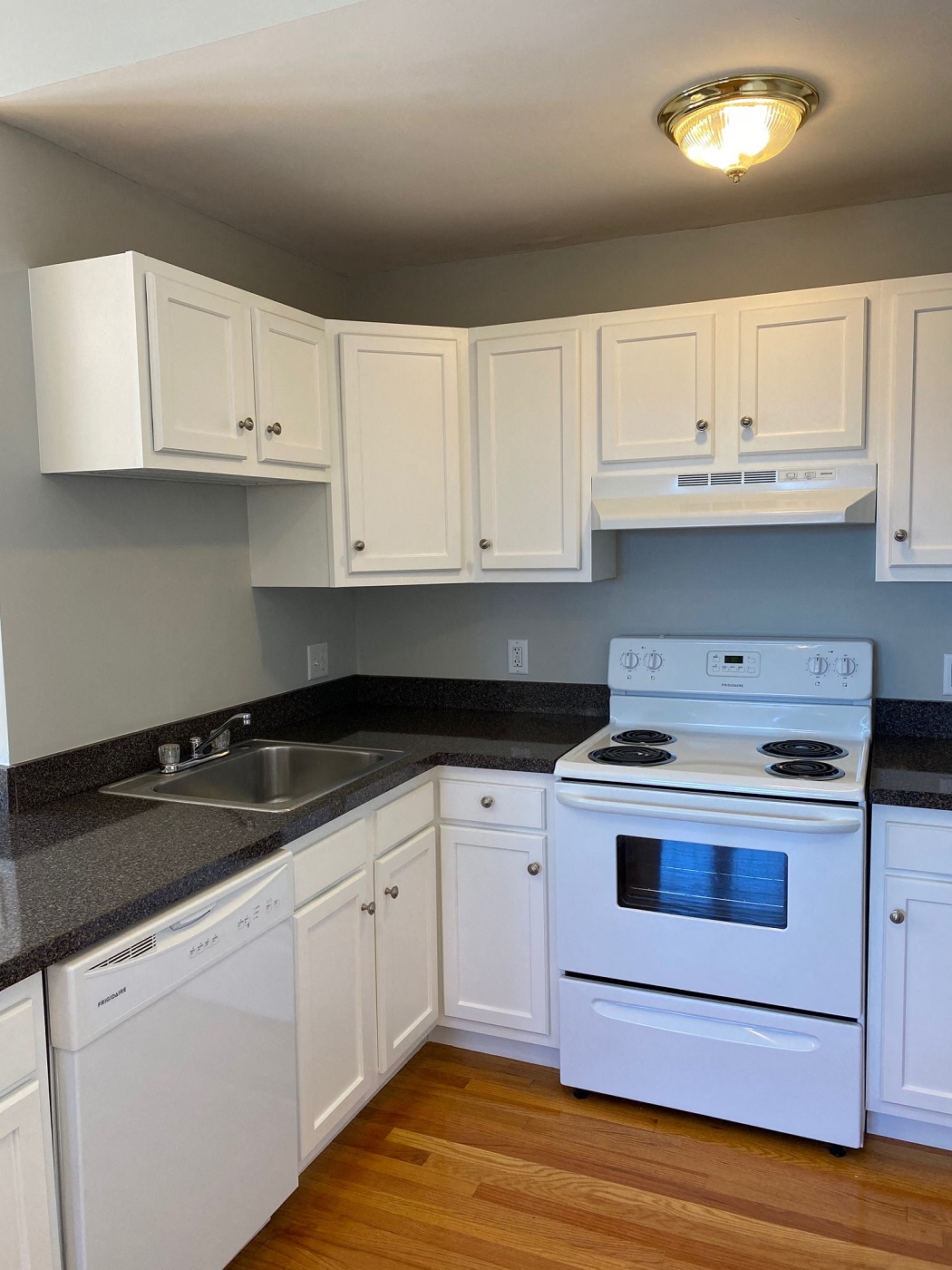 Kitchen with white cabinets and white appliances