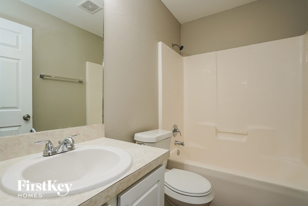 a bathroom with a sink and a toilet and a shower
