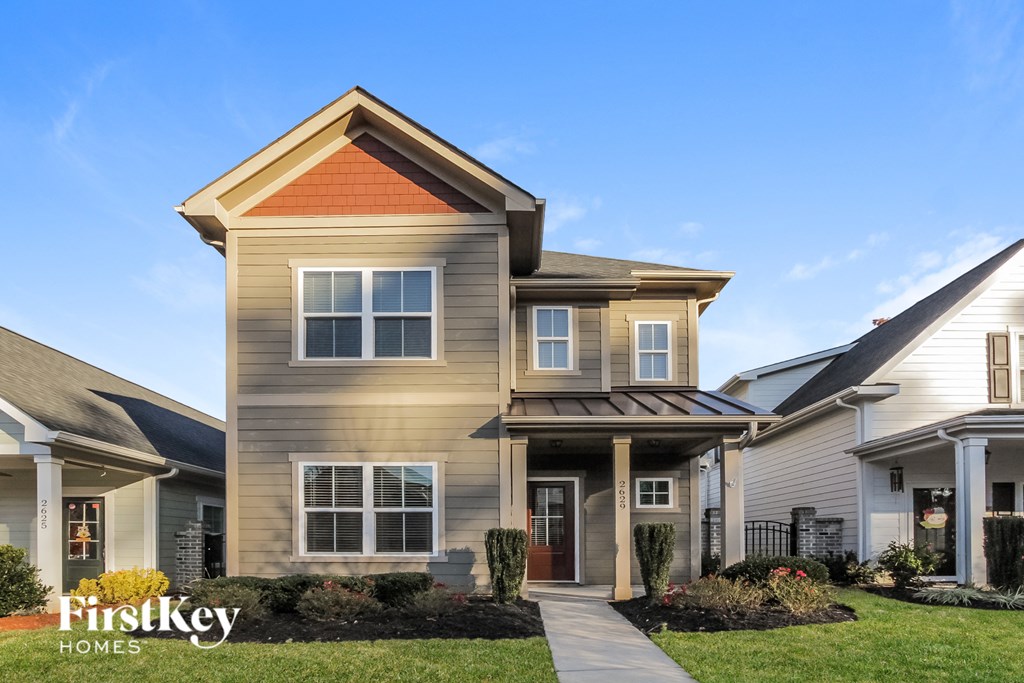 a house with a sidewalk in front of it