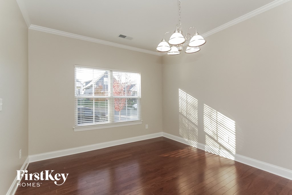 a living room with wood floors and a large window