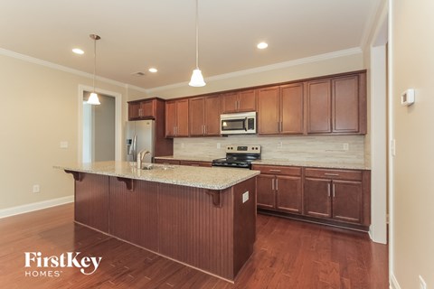 a kitchen with wooden cabinets and a granite counter top