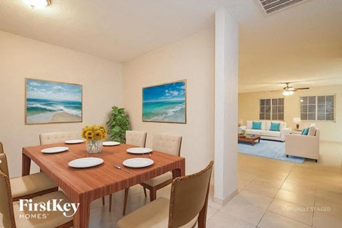 A dining room with a wooden table set for six.