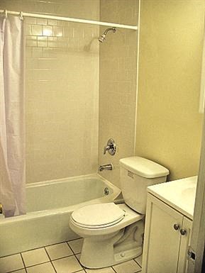 a bathroom with a toilet and a tub and a sink