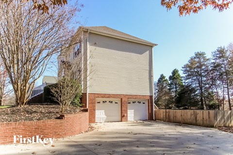 a church building with a garage and a driveway