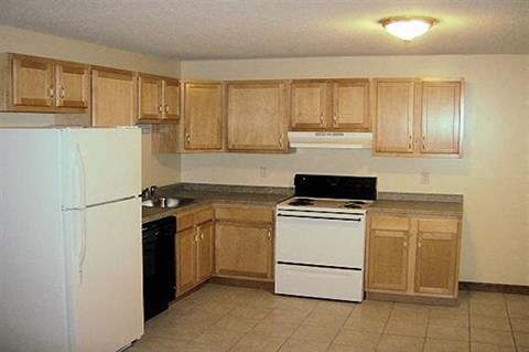 a kitchen with a stove and a refrigerator