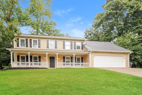 a large house with a green lawn in front of it