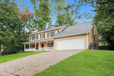 a house with a driveway and a white garage door