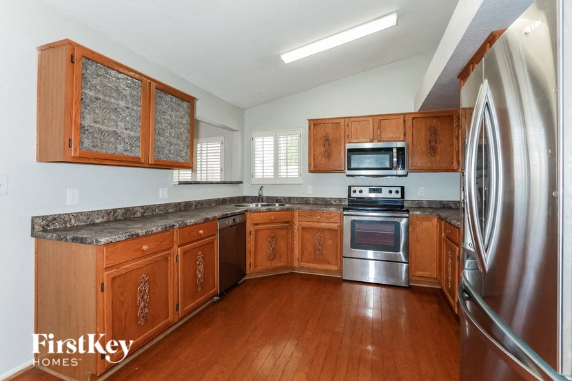 a kitchen with wooden cabinets and stainless steel appliances