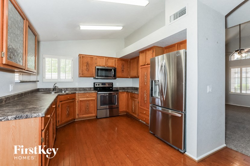 a kitchen with wooden cabinets and stainless steel appliances