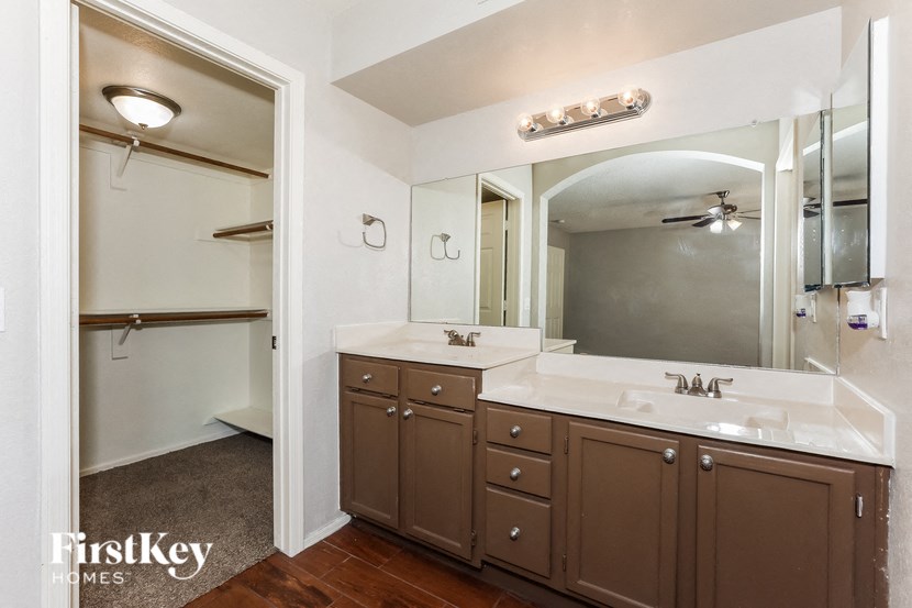 a bathroom with two sinks and a large mirror