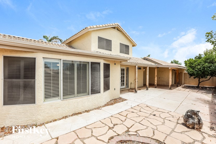 a house with a patio and a driveway in front of it