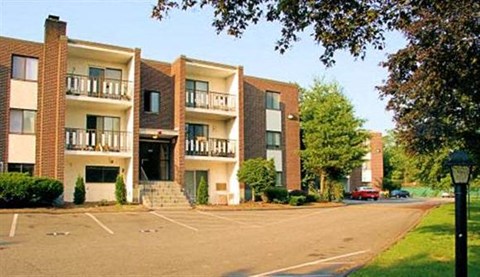 an empty parking lot in front of an apartment building