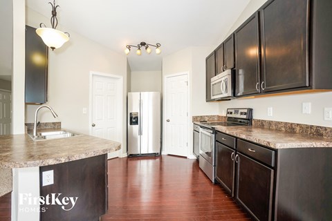 a kitchen with stainless steel appliances and granite counter tops