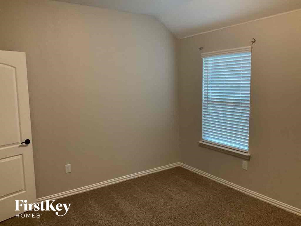 an empty room with a window and a door