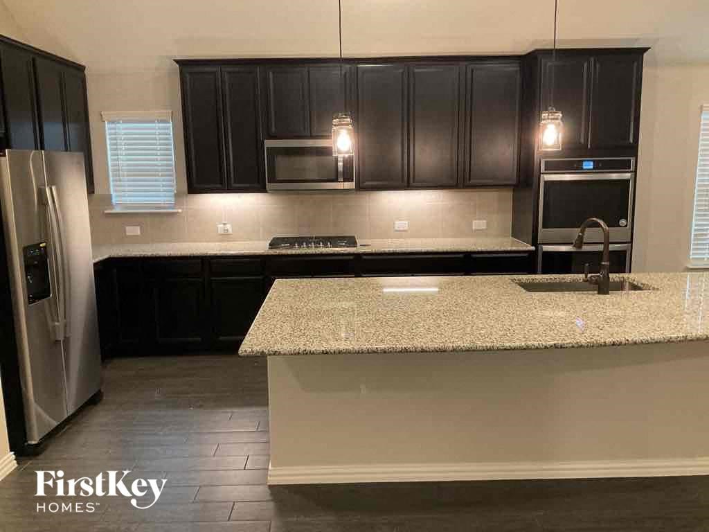 a kitchen with black cabinets and a counter top