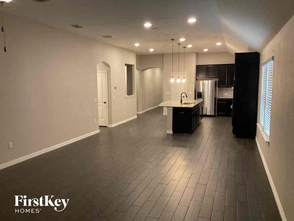 an empty living room and kitchen in a house
