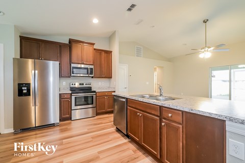 a kitchen with wooden cabinets and stainless steel appliances