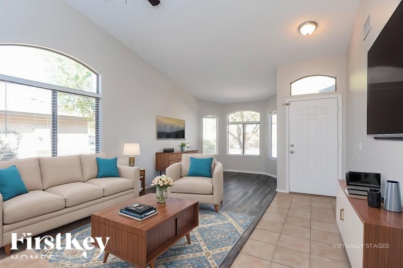 A living room with a couch, a coffee table, and a television.
