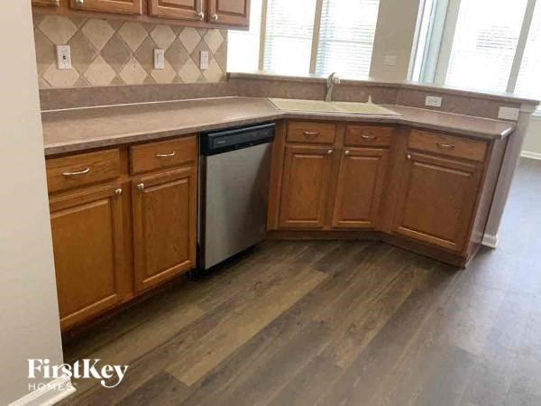 A kitchen with wooden cabinets and a dishwasher.