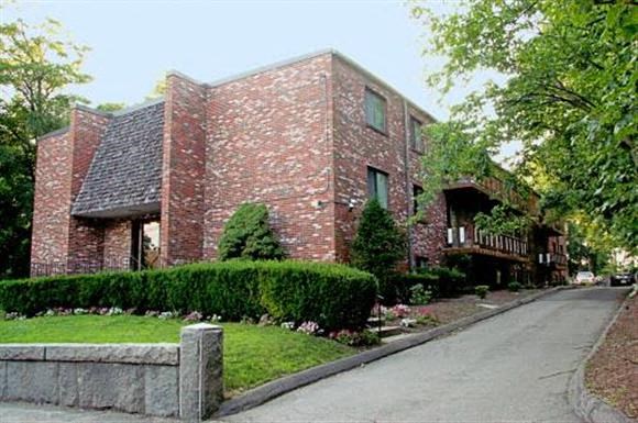 a brick house on the side of a street