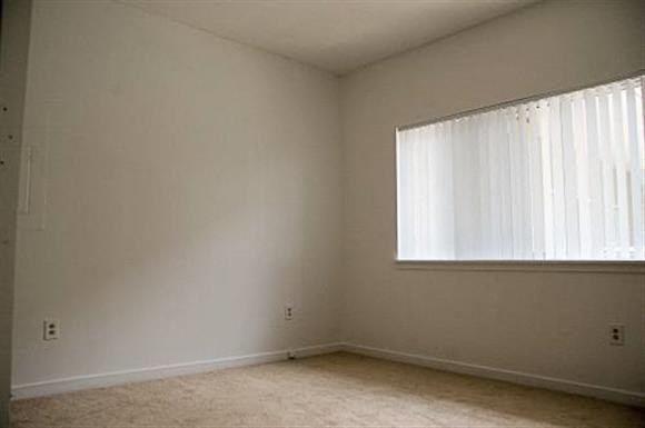 an empty living room with a large window