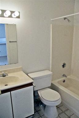 a bathroom with a toilet and a sink and a bath tub