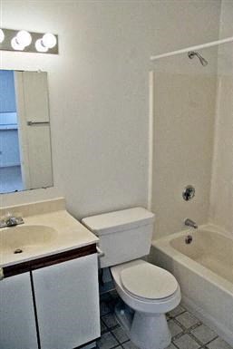 a bathroom with a toilet and a sink and a bath tub