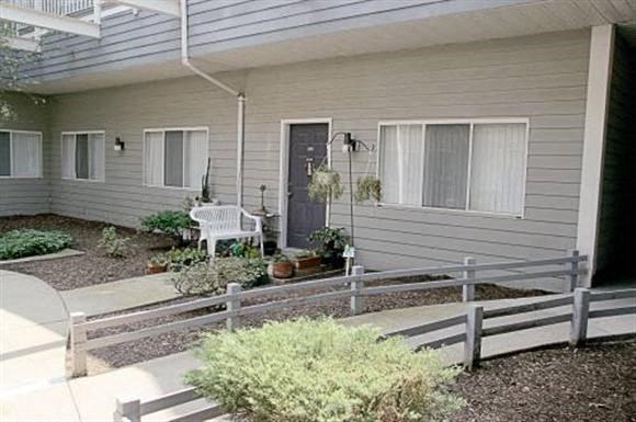 a white house with a porch and a white bench
