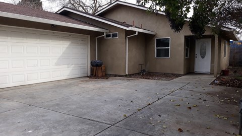 A house with a white garage door and a brown roof.