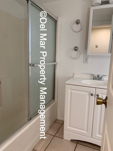 A small white bathroom with a sink and a shower.