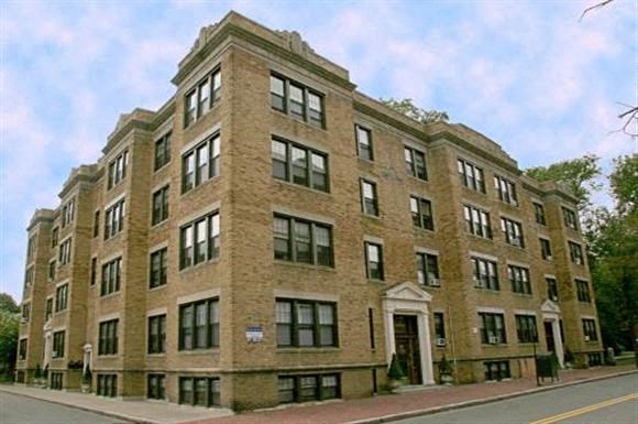a large brick building on the side of a street