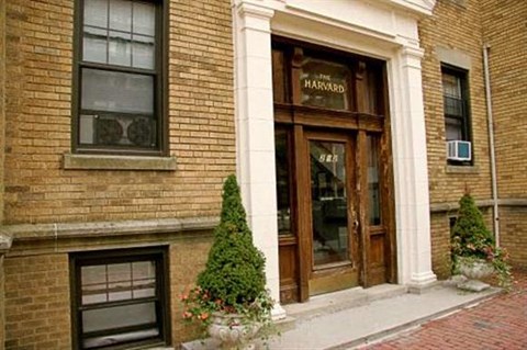 the front of a brick building with a wood door