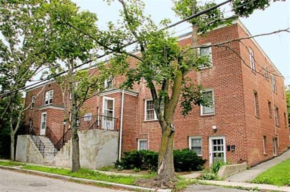 a red brick building with trees in front of it