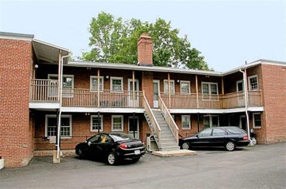 two cars parked in front of a building