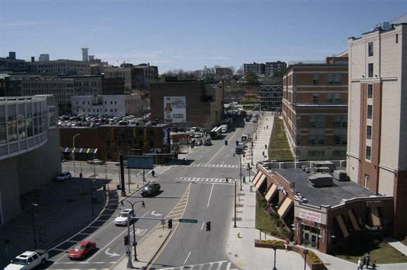 a view of a city street with cars and buildings