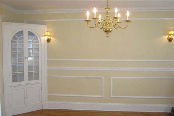 a dining room with a chandelier and a door