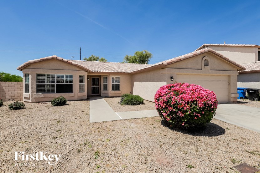 a house with pink flowers in front of it