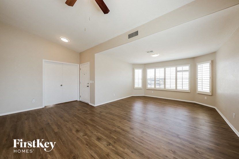 an empty living room with white walls and wood flooring