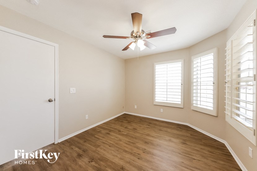a living room with a ceiling fan and a window