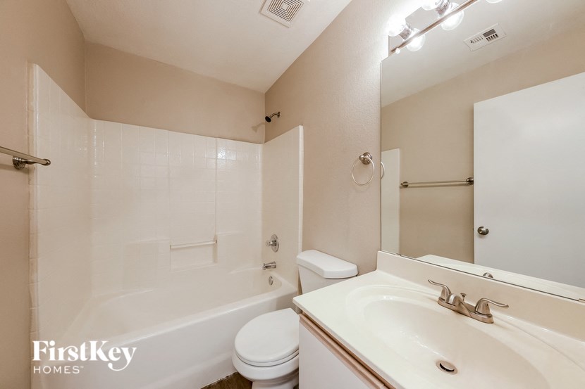 a bathroom with a sink toilet and a tub