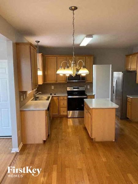 A kitchen with wooden cabinets and a white refrigerator.