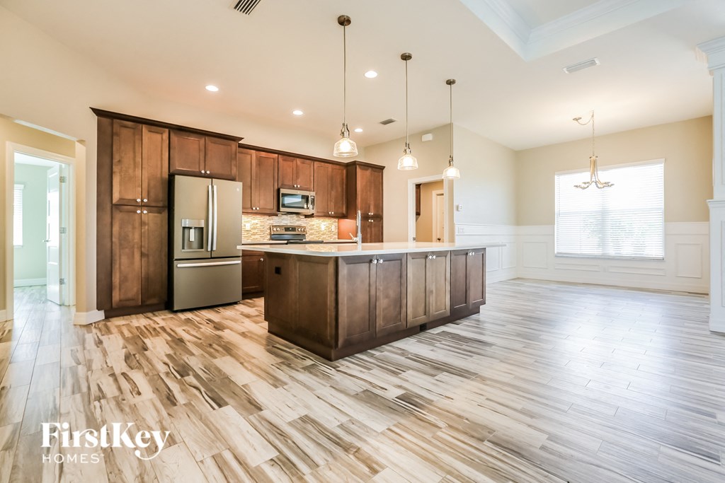 the kitchen is open to the living room and dining room