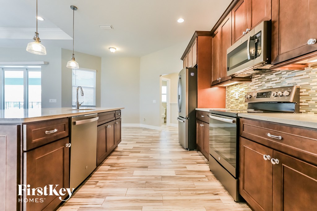 a kitchen with wooden cabinets and stainless steel appliances