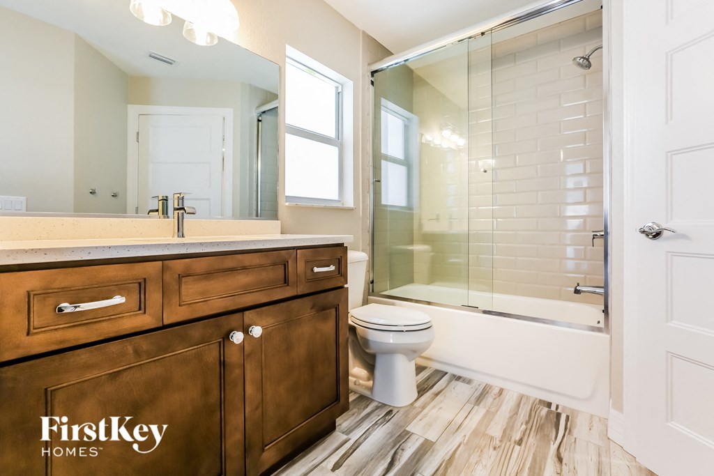 an image of a bathroom with a sink toilet and shower