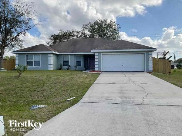 a blue house with a sidewalk in front of it